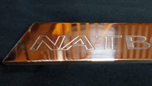 Part of the bronze frame showing the traditionally etched Nat Bowen logo