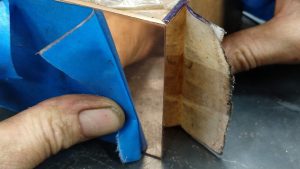Hand finishing the mitred corners of the bronze gallery plaque box sides for Nat Bowen's "Black Diamond" artwork
