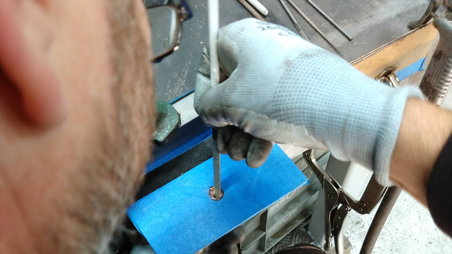 Needle filing the setting for the black diamond in Nat Bowen's bronze gallery plaque front plate