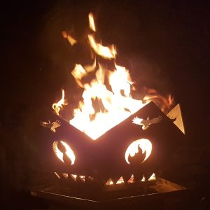 Ravens' Way Metalworks' own fire pit, with the famous "Elemental Ravens" custom design