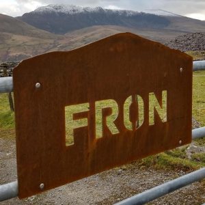 Mountain-shaped Corten weathering steel house name sign on a gate