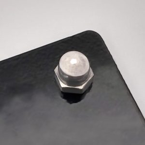 Metal sign fixing kit with standoff spacer in use on a black metal house sign