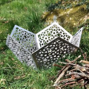 A silver bare steel Star of Morocco Fire Pit in our woodland