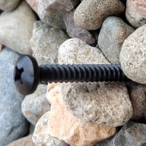 Black metal pan head sign fixing kit with standoff spacers for masonry in use