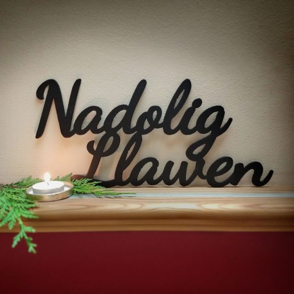 Nadolig Llawen black metal Merry Christmas decorative sign on a shelf