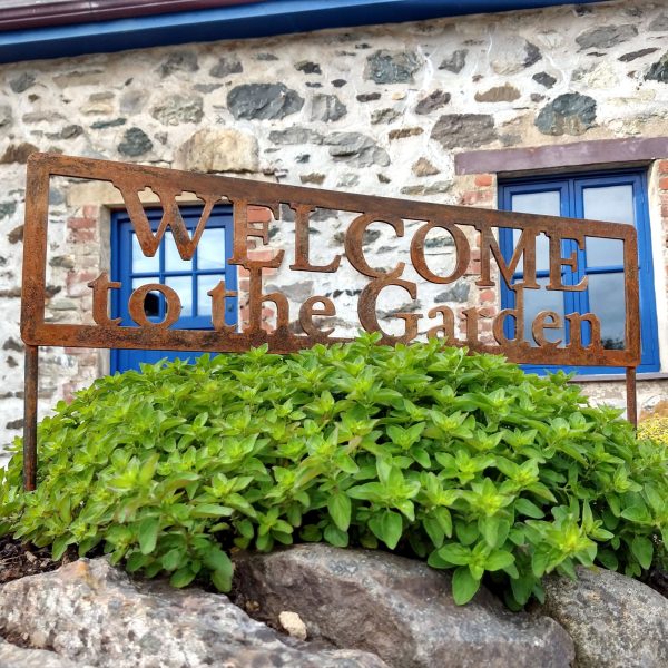 Rusty metal vintage-look Welcome to the Garden sign in our garden