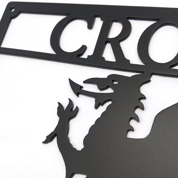 Closeup of Arwydd Metel Du Draig Cymreig Dwyieithog 'Croeso Welcome' Welsh Dragon Bilingual Fine Textured Black Metal House Sign in Welsh & English