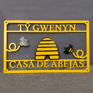 Completed multi-coloured bee-theme bilingual metal house sign