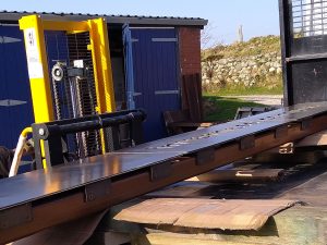 Loading the monolith signs for HIE Inverness onto specialist transport