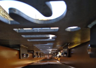 Closeup of underside of one monolith sign showing lugs and fixings