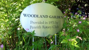 Completed oval laser-etched stainless steel garden sign and posts