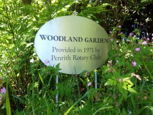 Completed oval laser-etched stainless steel garden sign and posts