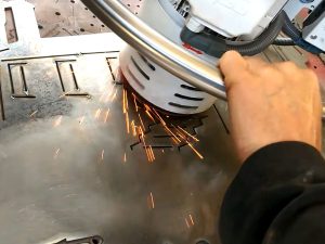 Deburring and edge rounding the front panel using a swing grinder
