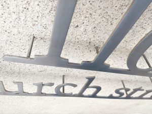Closeup of the hidden mounting studs at the back of the sign